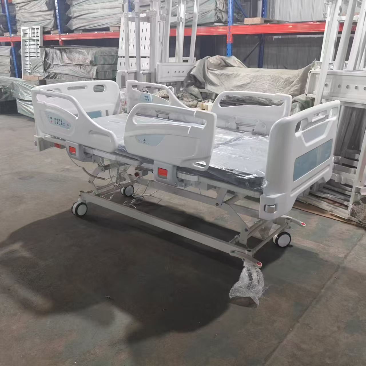 High end electric five function ICU hospital bed with split ABS rails and central brake in factory testing bay