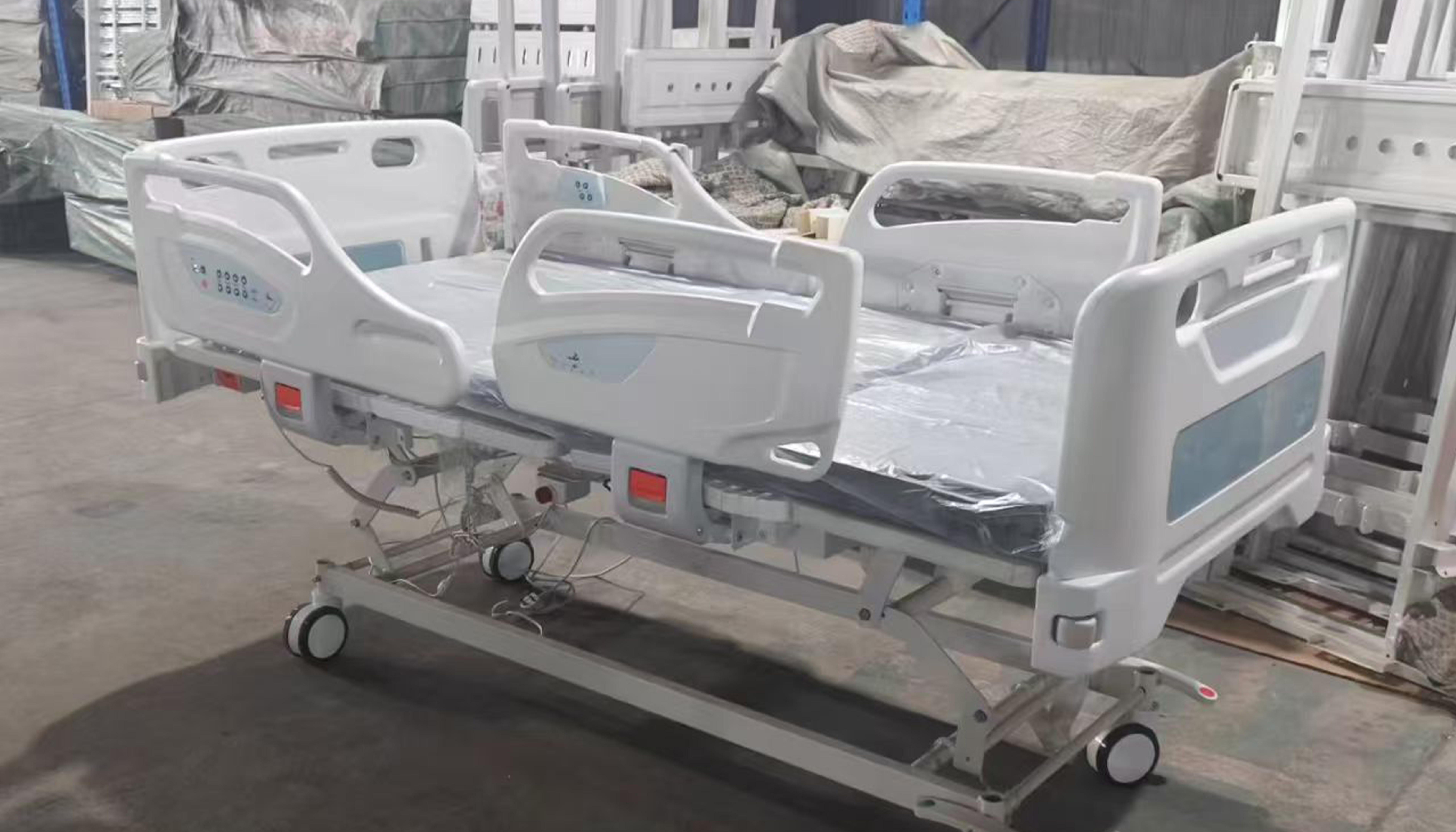 High end electric five function ICU hospital bed with split ABS rails and central brake in factory testing bay